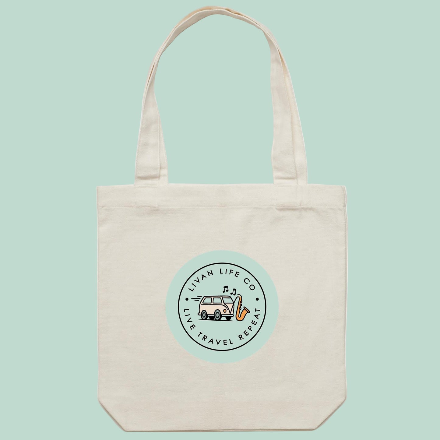 Beige tote bag with a circular logo featuring a van and text on a white background