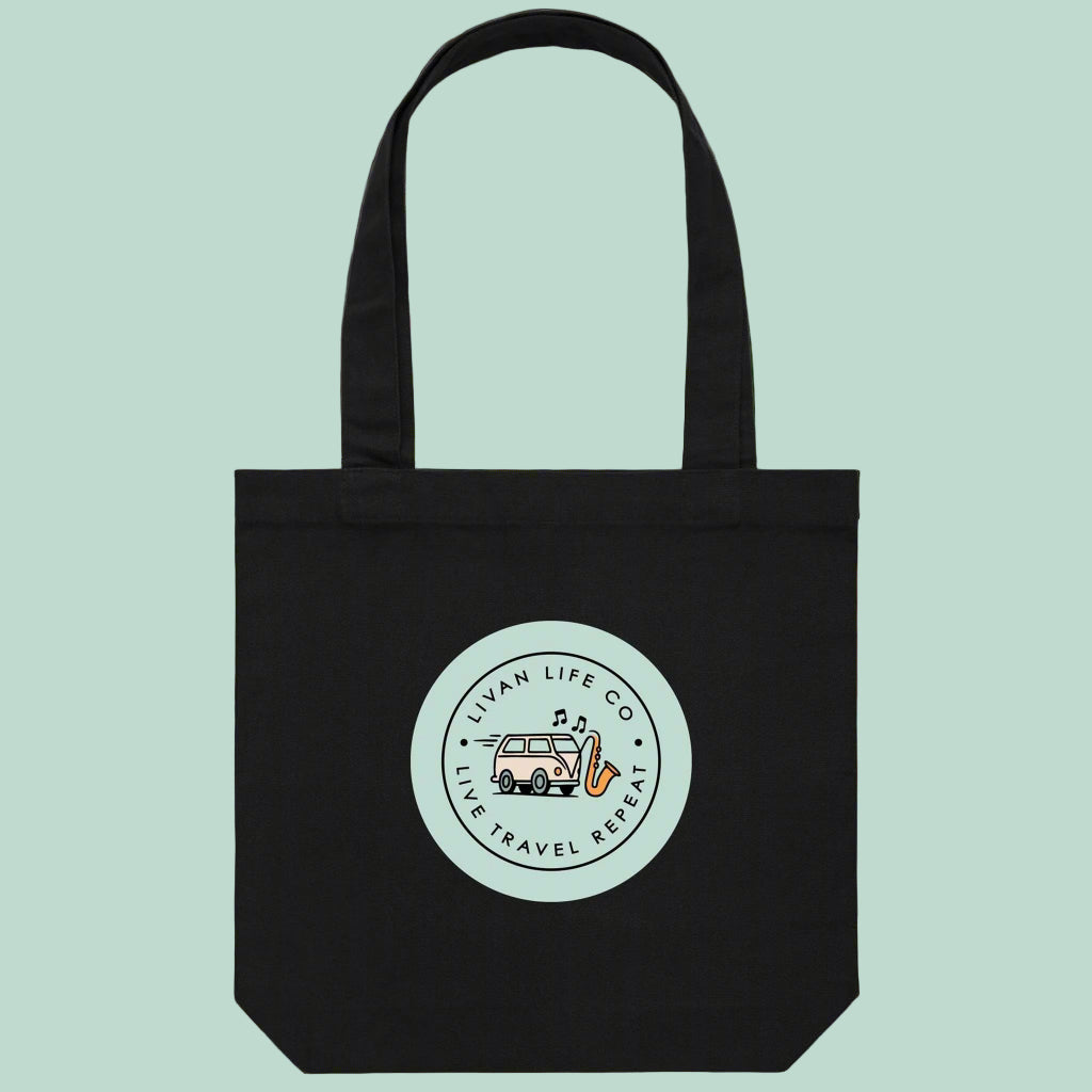 Black tote bag with a circular logo on a light green background