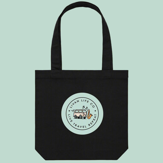 Black tote bag with a circular logo on a light green background